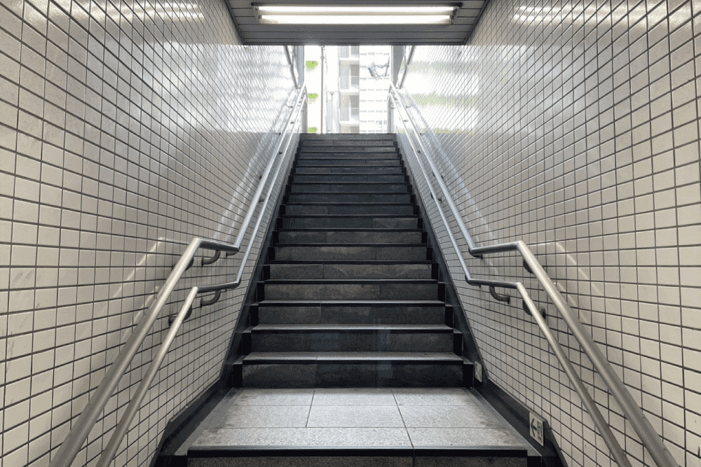 Stairs to the ground level of Higashi-Shinjuku Station