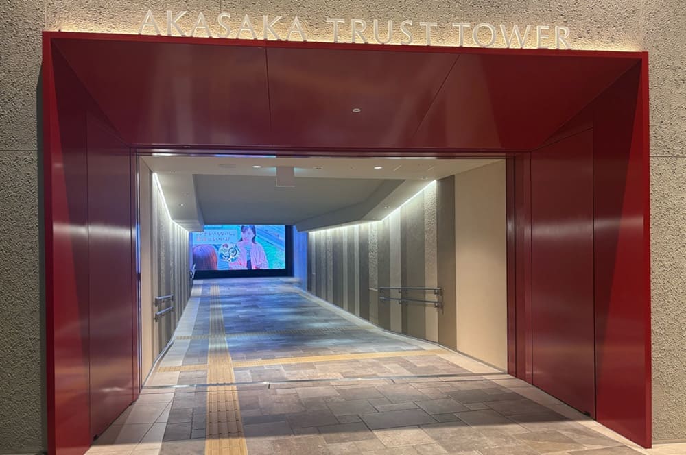 The entrance to the passage is framed by a bright red border bearing the words 