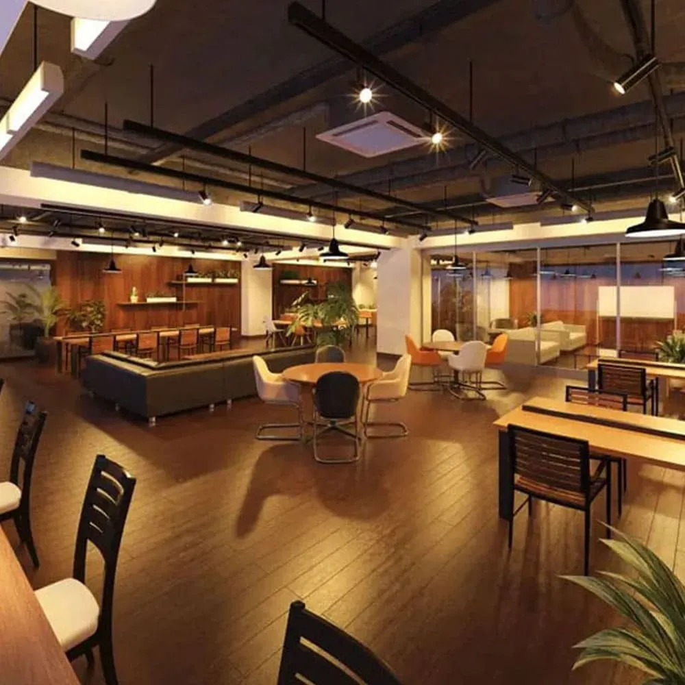 This is an interior shot of a modern and open co-working space with wooden floors and various seating arrangements.
