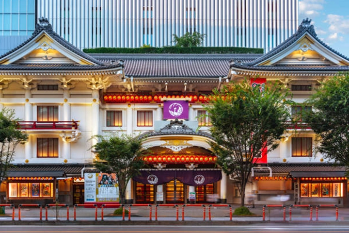 The traditional exterior of the Kabukiza Theatre in Ginza, contrasted with the modern high-rise building behind it.