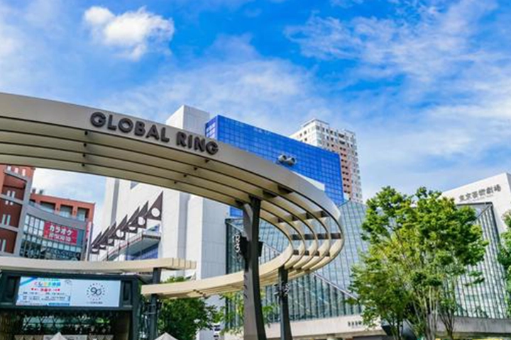 The exterior of the Tokyo Metropolitan Theatre in Ikebukuro, with the Global Ring monument in the foreground.