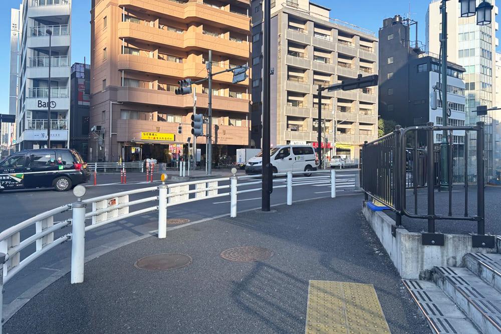 An intersection with white guardrails.