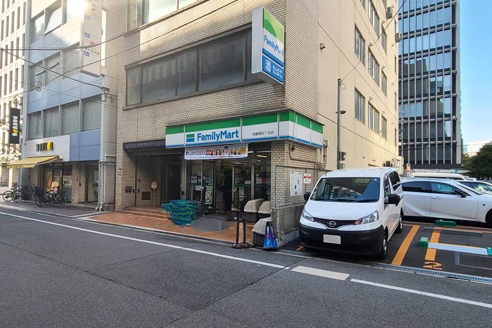 The exterior of Japan Resort Building, which houses [Family Mart] on the first floor.
