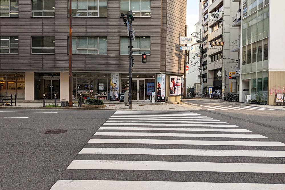 The crosswalk immediately to the left after exiting Exit 7 at Higobashi Station.