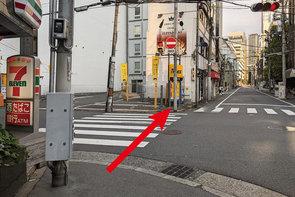 The crosswalk in front of [Seven-Eleven]. Once you cross, you can see [Times].
