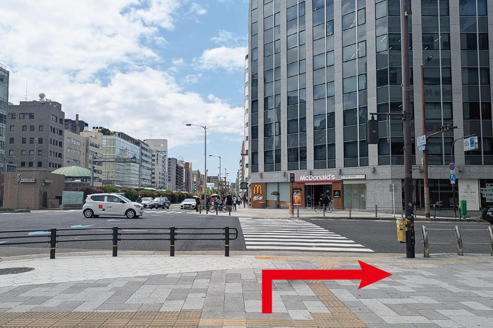 A crosswalk in Shin-machi 1-chome, Nishi-ku, with a [McDonald] visible in the background.